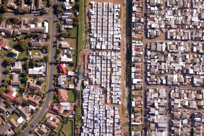 Aerial image of a township and wealthy suburb.