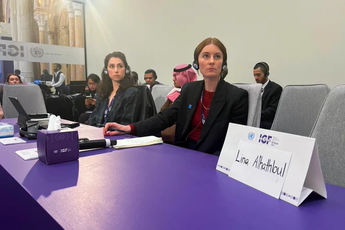 A sign stands in front an empty seat for Saudi human rights activist Lina al-Hathloul, during the Internet Governance Forum in Riyadh, on December 18, 2024. © 2024 Haitham El-Tabei/AFP via Getty Images
