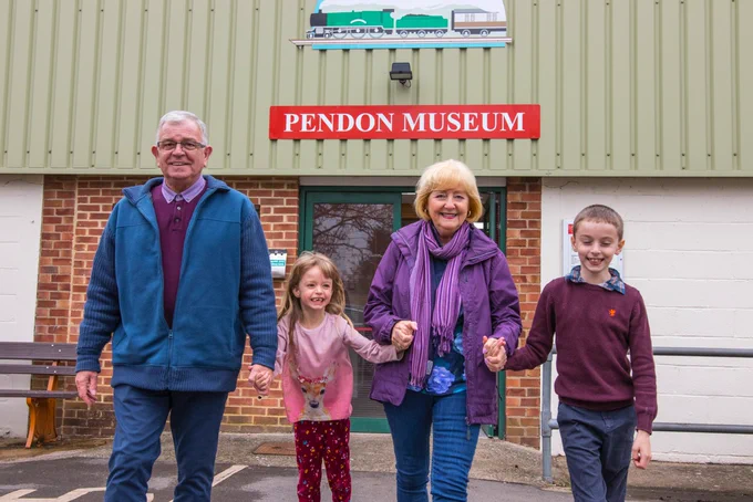 Adult and child visitors outside the entrance to Pendon Museum