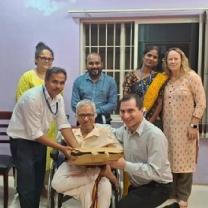 Behdin Nowrouzi-Kia receives a welcome gift from Sankara Raman, Secretary and Ram Ponnusamy, Director Clinical. In the background is Franzina Coutinho,  Doss Prakash,  Navamani and Andrea Duncan.