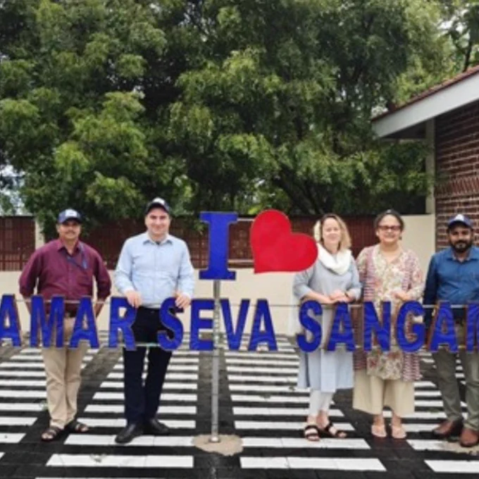 Andrea Duncan and Behdin Nowrouzi-Kia (University of Toronto), Doss Prakash (Mahatma Gandhi Mission University), Franzina Coutinho and Ram Ponnusamy (Amar Seva Sangam) stand in front of the Amar Seva Sangam sign in Ayikudy, Tamil Nadu, India