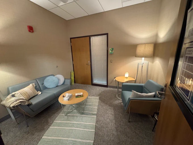 View of room with warm lighting and comfortable furniture seating