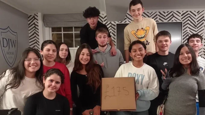 A group of smiling young people holding a sign with the number £175.