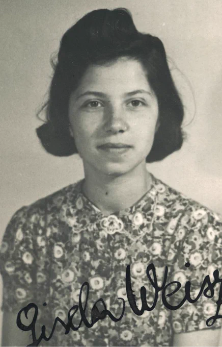 Black and white portrait of a woman wearing a floral dress, with the name Gisela Weisz signed at the bottom.