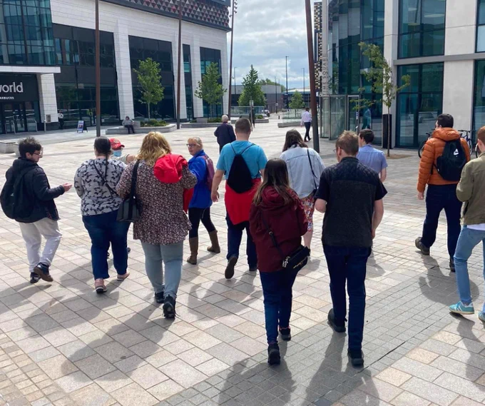 A group of people walking in the community