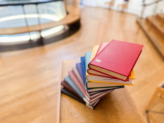 Multicoloured books in a rainbow arrangement. 