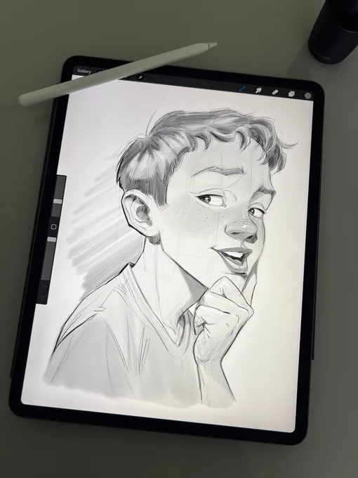 A pencil sketch of a boy on an iPad Pro