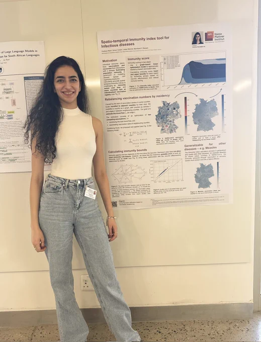 Ferdous joyously next to her poster at UCT.