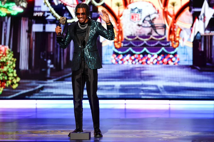 Photo of Jayden Daniels on stage at NFL Honors accepting the award for Moment of the Year. 