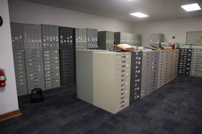Microfilm cabinets occupy a corner of a library.