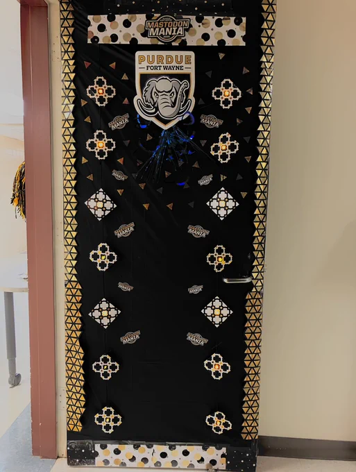 Door decorated for Mastodon Mania with Mastodon and gold and black decorations and lights with Mastodon Mania logo