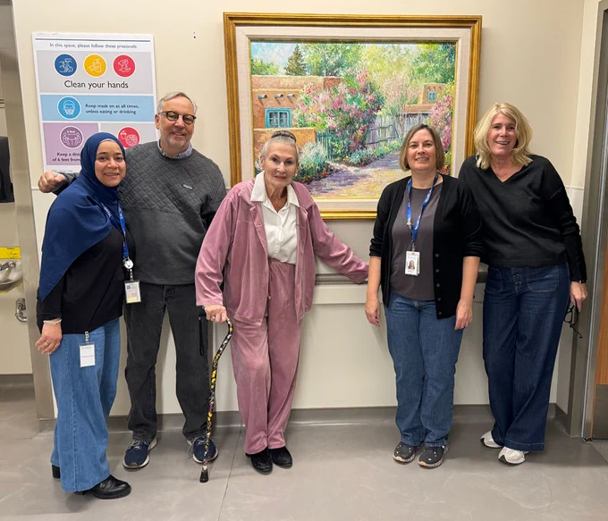 A warm gathering around the painting Luella’s Lilac Lane, 1996 by Joseph U. Horton in a hallway of Etobicoke General Hospital's Cancer Centre includes (left to right) Samar Saeed, Manager – Oncology, ArtWorks for Cancer board members Michael Weinberg and Beverly Schaeffer, Patricia Mosnia, Clinical Director – Oncology and Palliative, and ArtWorks for Cancer board member Sharon Suter.