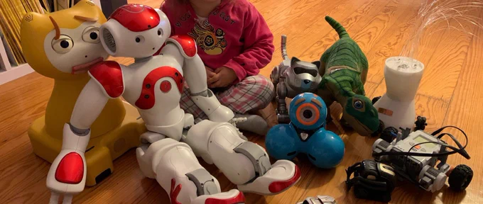 A set of robots and a child on the floor