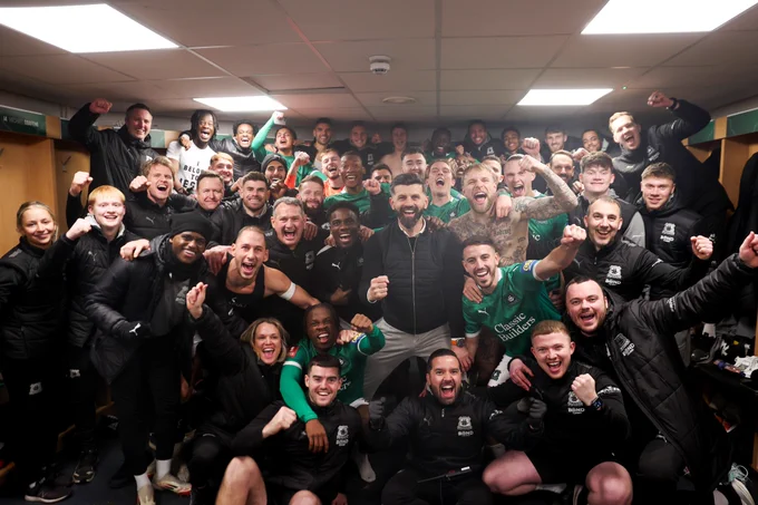 A shot of the Argyle players and staff in the dressing room after beating Liverpool.