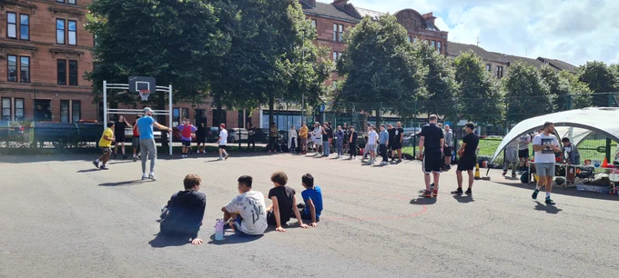A basketball event taking place at an outdoor court in Glasgow. 