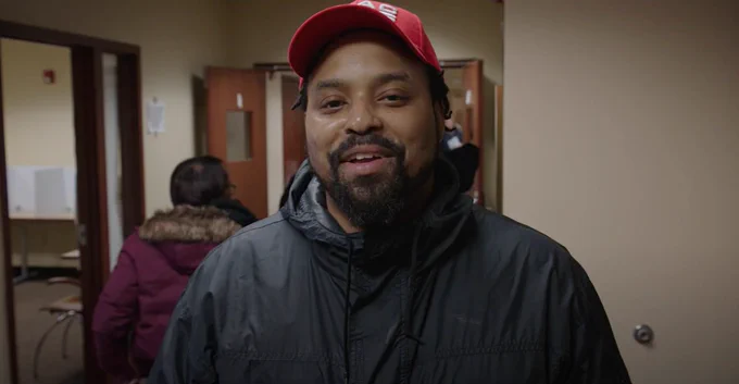 Screenshot of a smiling UAW member from a video about the new contract Local 163 members won at Detroit Axle that includes profit-sharing and COLA for the first time ever at the company. 