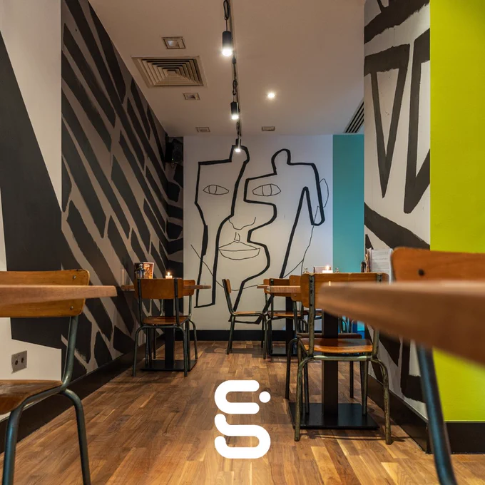 A picture of the interior of the Third Eye Bar, featuring a colourful wall mural.