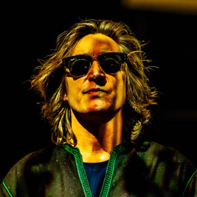 Mike Garry Poet, with long dark hair wearing sunglasses