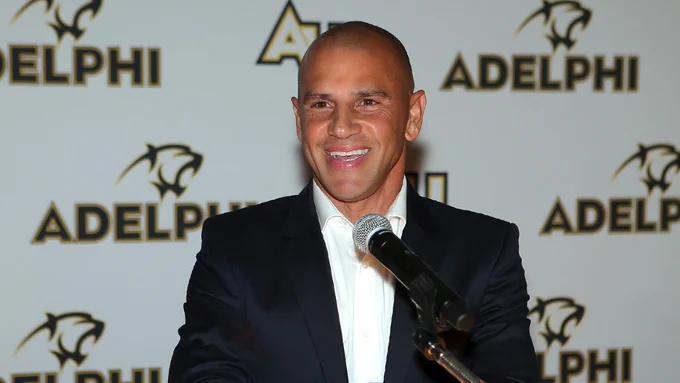 Chris Armas '94 with the Adelphi background behind 