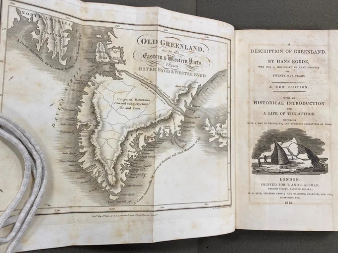 Photo of 1818 book opened to title page and frontispiece (foldout map of Greenland).