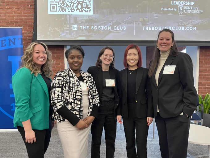 5 women standing on a stage