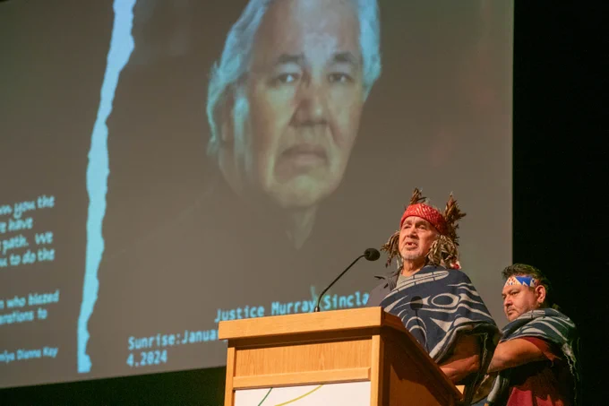University of the Fraser Valley resident Elder Stephen Williams speaking at the podium in the Mission Clarke Theatre