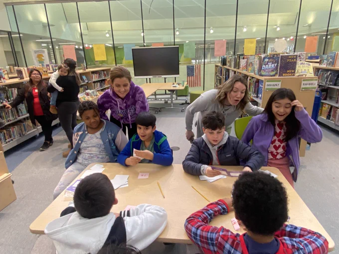 Students teachers around a table with cards