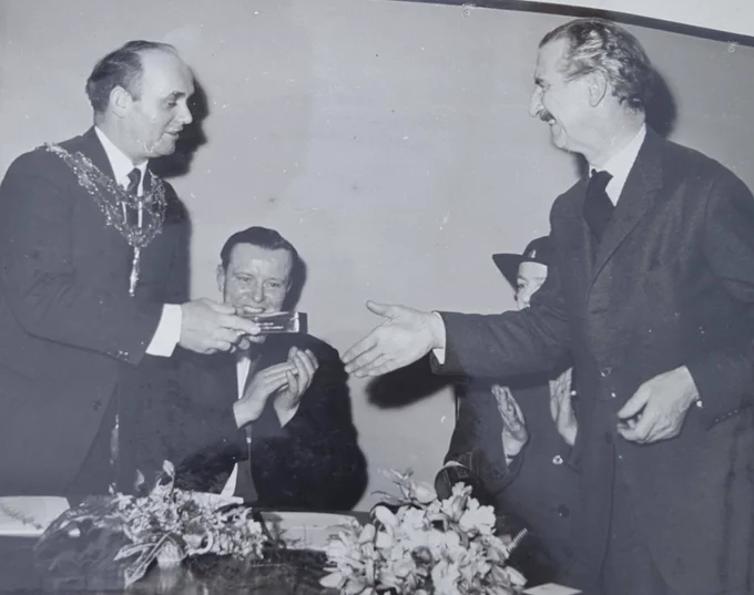 Chairman of Nuneaton and Bedworth Harry Rowston receives a silver cigarette case from architect of the Newtown Building Sir Frederick Gibberd