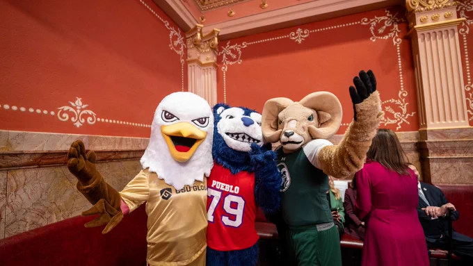 CAM the Ram posing for a picture with C S U Pueblo mascot Wolfie the thunder wolf and C S U Global mascot Goldie the eagle at the Colorado State Capitol on C S U Founders Day. 