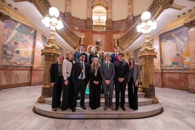 CAM the Ram posing for a picture with C S U President Parsons and A S C S U representatives at the Colorado State Capitol on C S U Founders Day. 
