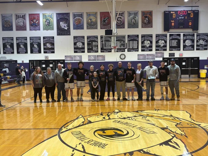 Seniors stand with parents and family members