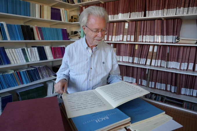 Jos van Veldhoven looks through a Bach work in the Oregon Bach Festival music library