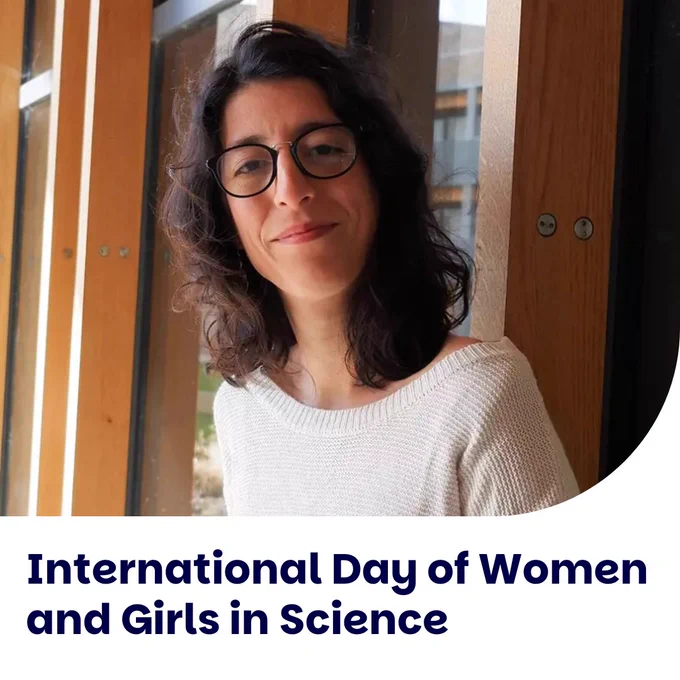 Individual smiling at the camera on the International Day of Women and Girls in Science.