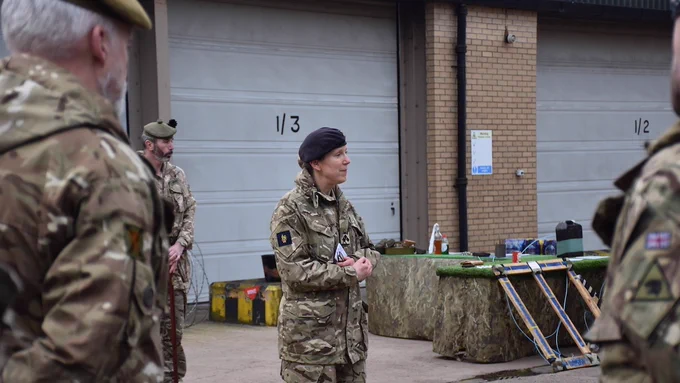 The 19th Light Brigade Commander talking with three soldiers in view.