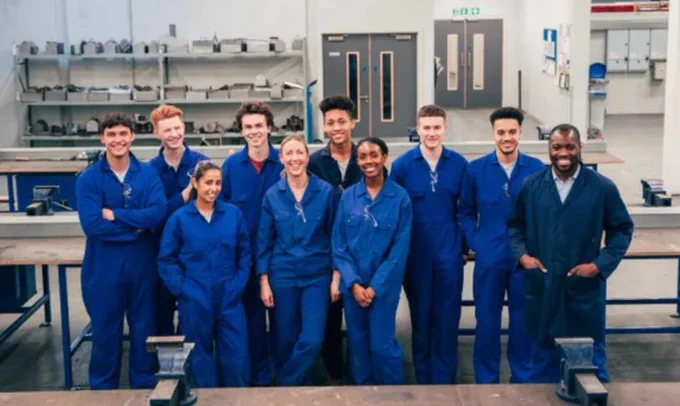 A workforce wearing overalls pictured in their workshop.