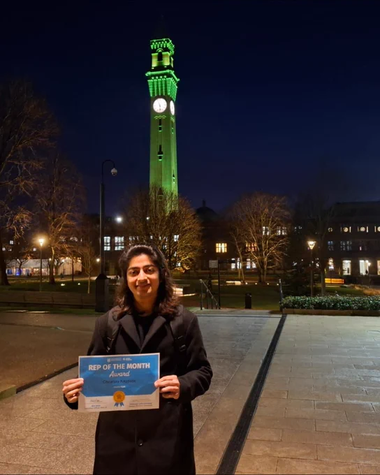 Image of a student smiling in front of Old Joe having won Rep of the Month for January.