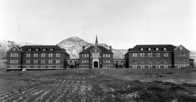black and white photo of a three story school building