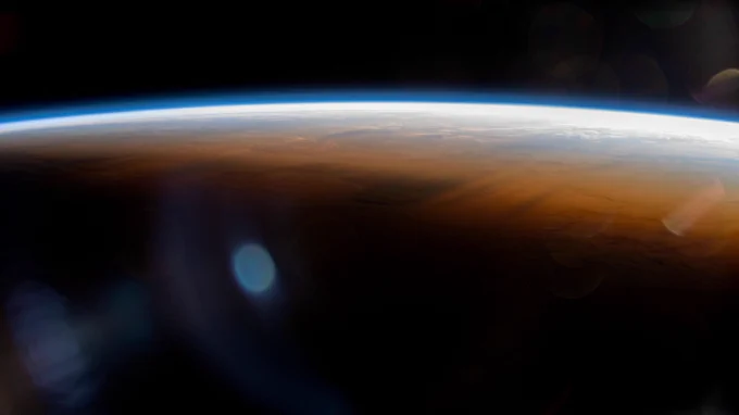 The International Space Station orbits 264 miles above the Atlantic Ocean off the coast of Namibia and into an orbital sunset marked by the terminator, or the line separating day from night on Earth. Credit: NASA