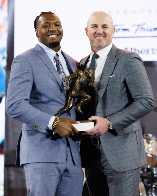 Jason Witten and J.J. Weaver hold the colelgiate man of the year award