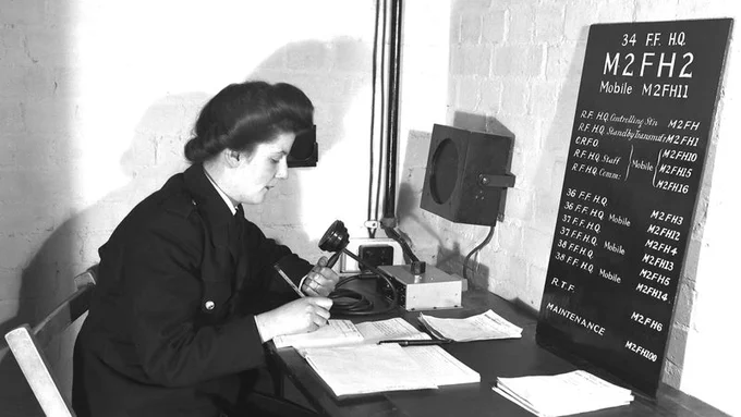 National Fire Service radio operator at the radio desk, Fire Force Area 34, Ealing HQ. Taken in around 1944