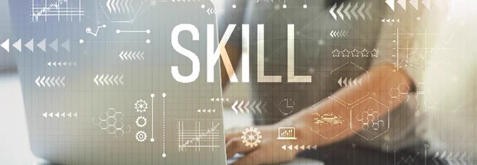 background image - person working at laptop with the word 'skill' in the foreground