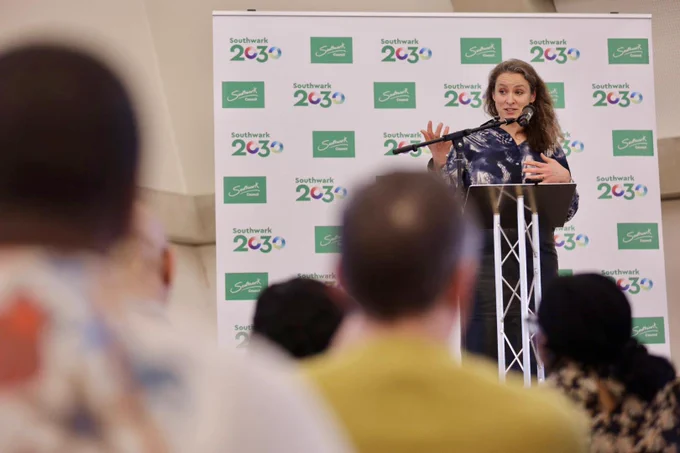 An image of Sarah Gillinson standing on a stage speaking at Southwark 2030