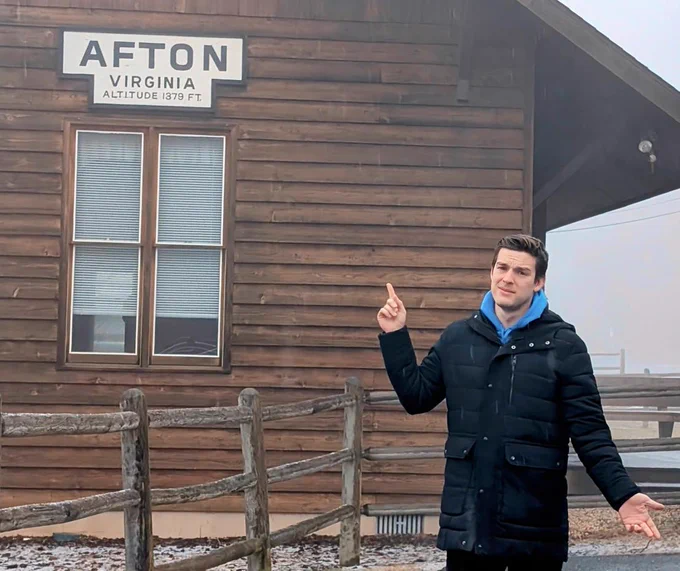 MatPat standing outside a log cabin in Afton, Virginia