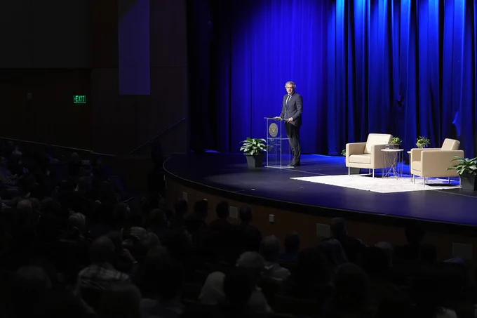 Chancellor Diermeier speaks on stage during the Darwin Day Lecture in Langford auditorium. 

