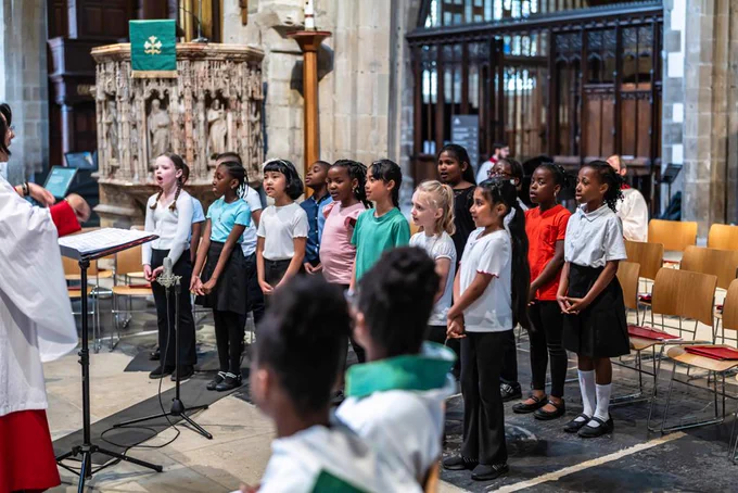 Primary school children singing in a cathedral
