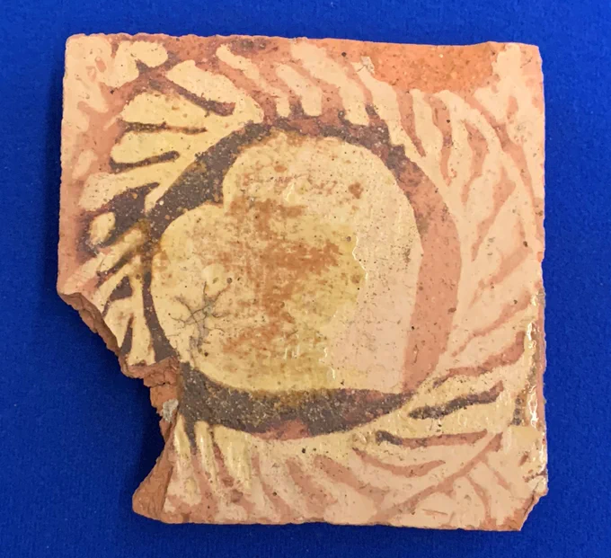 Medieval tile with a pattern containing a heart