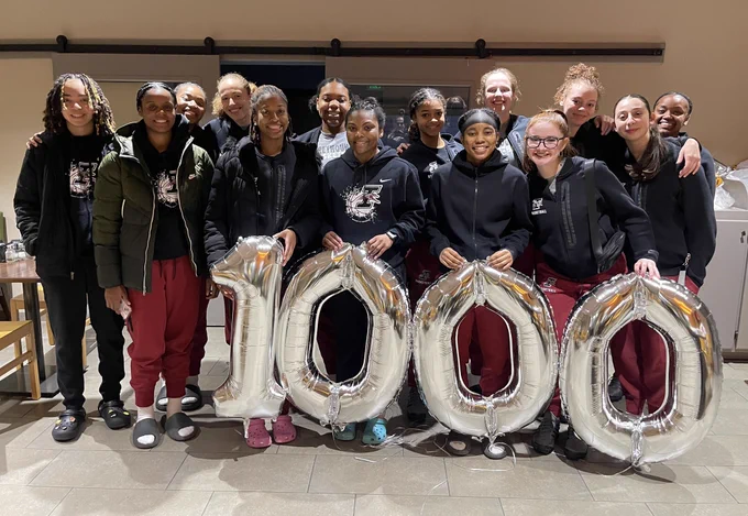 Elana and the team pose in front of 1000 balloons.
