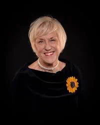 Tricia was born in Sunderland in the North East of England. She trained as a diagnostic radiographer and after moving to Skipton in Yorkshire in 1973, with her husband Ian, Tricia worked at Airedale General Hospital.
After they moved into a small village of Cracoe in the Yorkshire Dales, a neighbour, Angela Baker invited her to join the WI, telling her that the locals would think she was funny if she didn’t join.
In February 1998 John Baker, Angela’s husband, was diagnosed with non Hodgkins Lymphoma. Sadly he died just five months later and, to raise funds in his memory, Tricia’s idea for the alternative WI calendar was born.