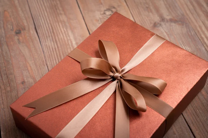A wrapped book with a bow on it.