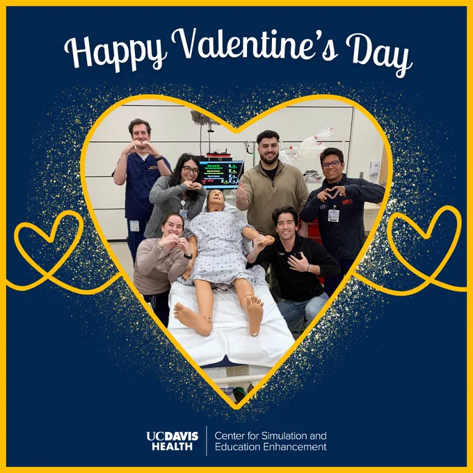 Picture of six people making heart signs with their hands next to a simulation manikin. The text says "Happy Valentine's Day" with the simulation center logo at the bottom.